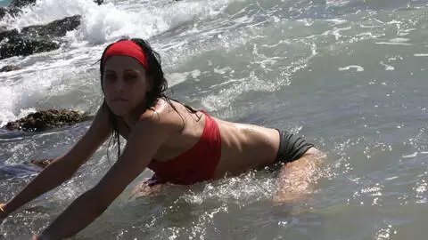 Pretty young brunette Barbara Nux doing a strip in the rocks  photo 5