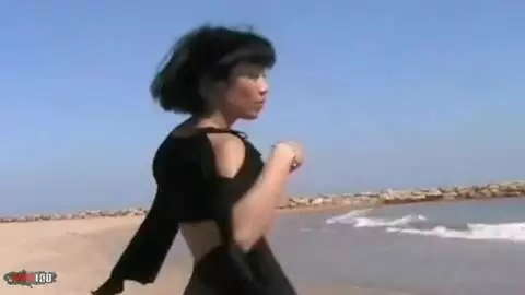 Lovely oriental Betty getting naked by the sea  photo 05