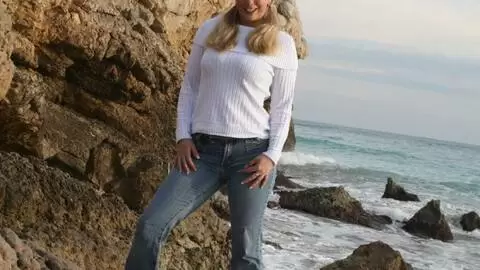 Pornostar young blonde with big boobs Calia B doing a strip by the sea  photo 1