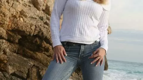 Pornostar young blonde with big boobs Calia B doing a strip by the sea  photo 2