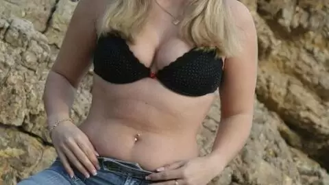 Pornostar young blonde with big boobs Calia B doing a strip by the sea  photo 4