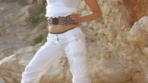 Hot blonde with big tits Electra removing clothes in the rocks  photo 2