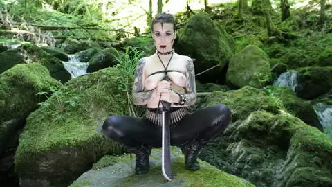 The beautiful French brunette Irogenia does a striptease in a warrior outfit photo 11