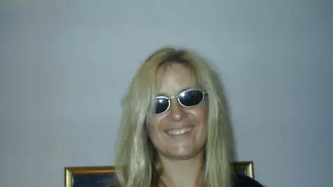 Hot mature blonde with big tits Martha removing clothes on the bed  photo 1