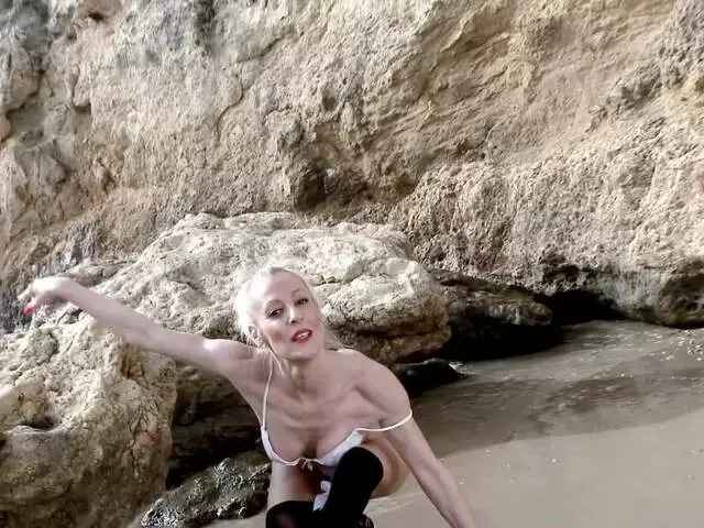 MILF blonde Yelena Vera doing a hot striptease by the sea  photo 5