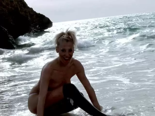 MILF blonde Yelena Vera doing a hot striptease by the sea  photo 10